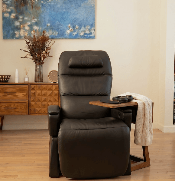 Room corner with a black reclining chair, dresser, dried flowers and framed art